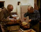 1999 Thanksgiving Potluck - Jack Culver & John Gorton carve turkeys